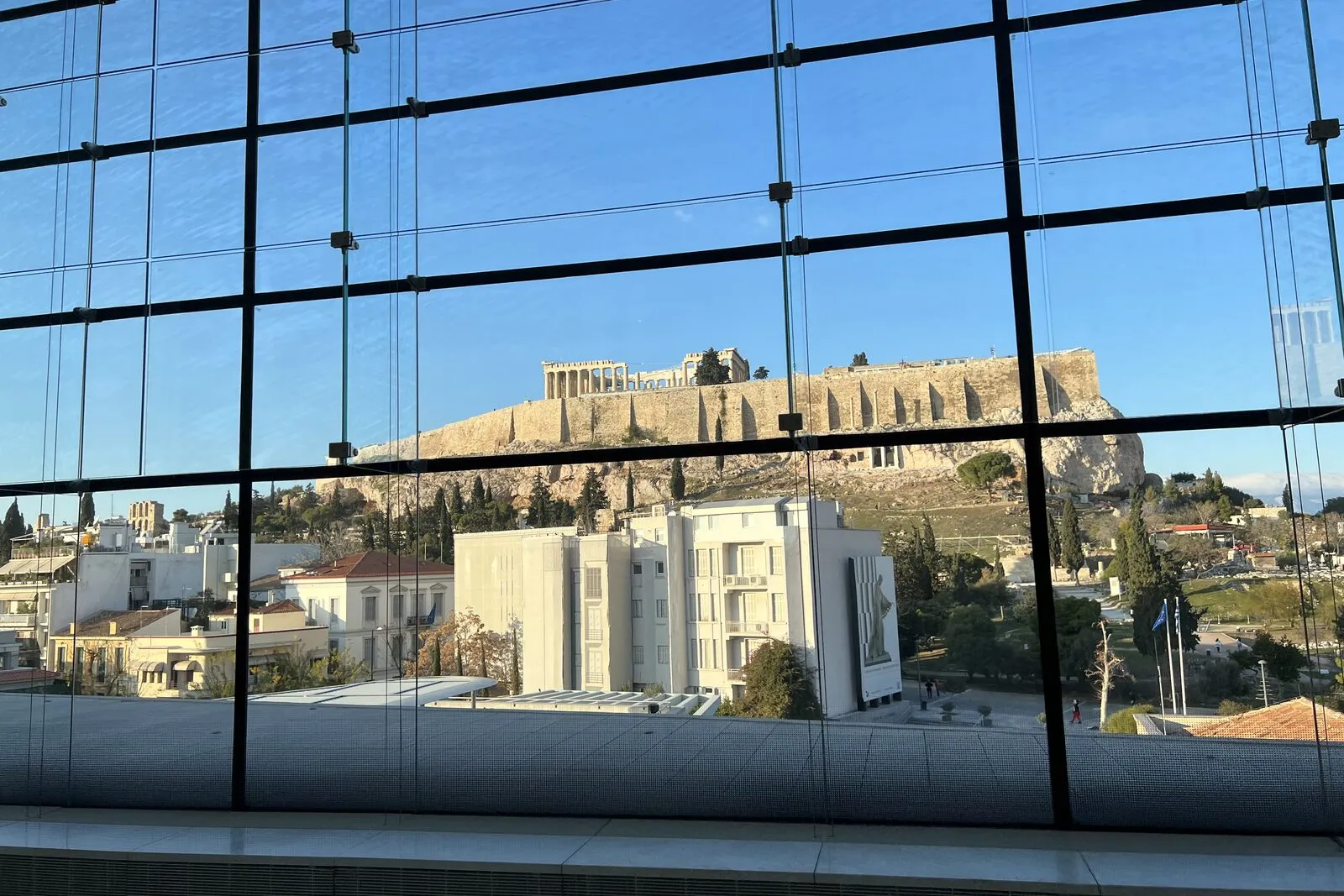 The Acropolis Museum in Athens with the Acropolis rising behind it