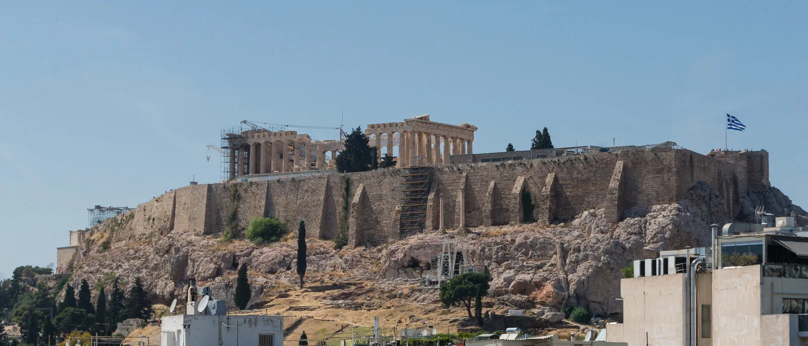 The Acropolis and Parthenon on their rocky hill in Athens, seen across the city