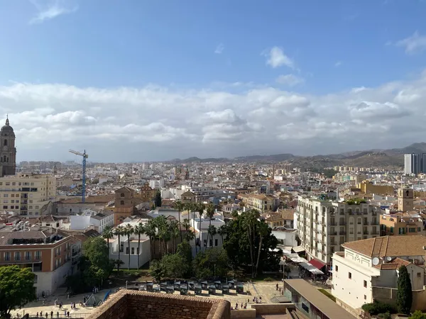 The city of Málaga seen from the Alcazaba, with the cathedral tower and the mountains behind