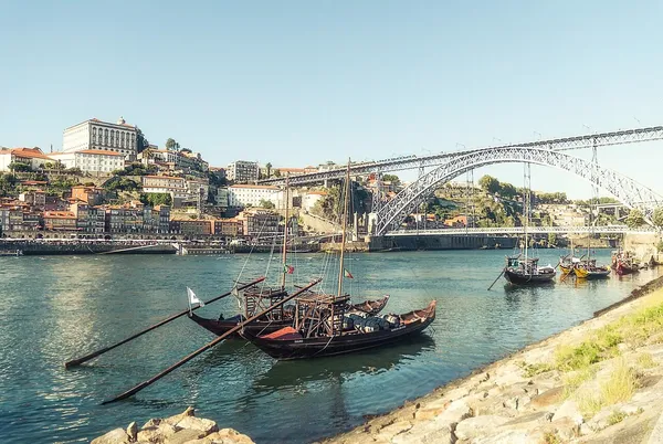 The Dom Luis I bridge and the Douro river with the Ribeira waterfront and rabelo boats in Porto, Portugal