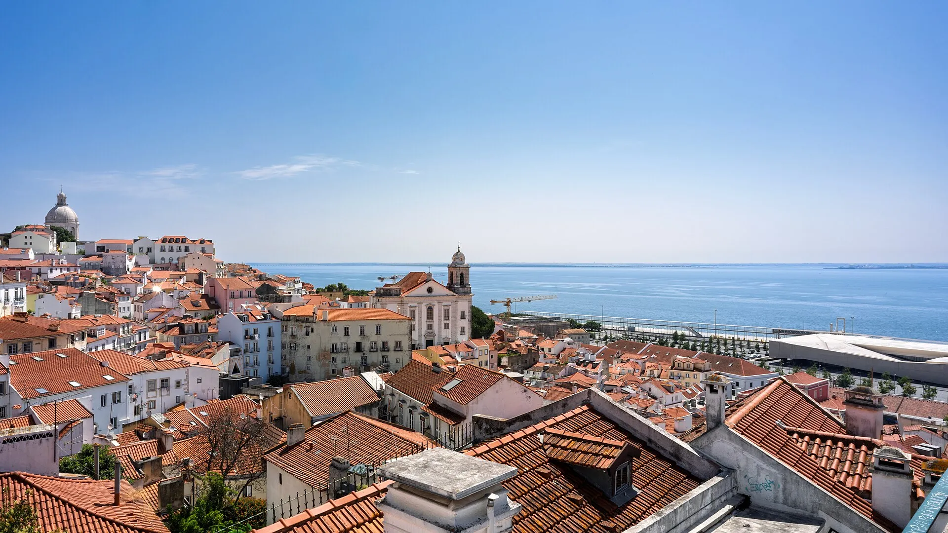 The rooftops of Alfama and the Tagus river seen from a Lisbon viewpoint