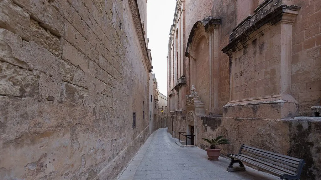 A quiet narrow street between stone buildings in Mdina, Malta