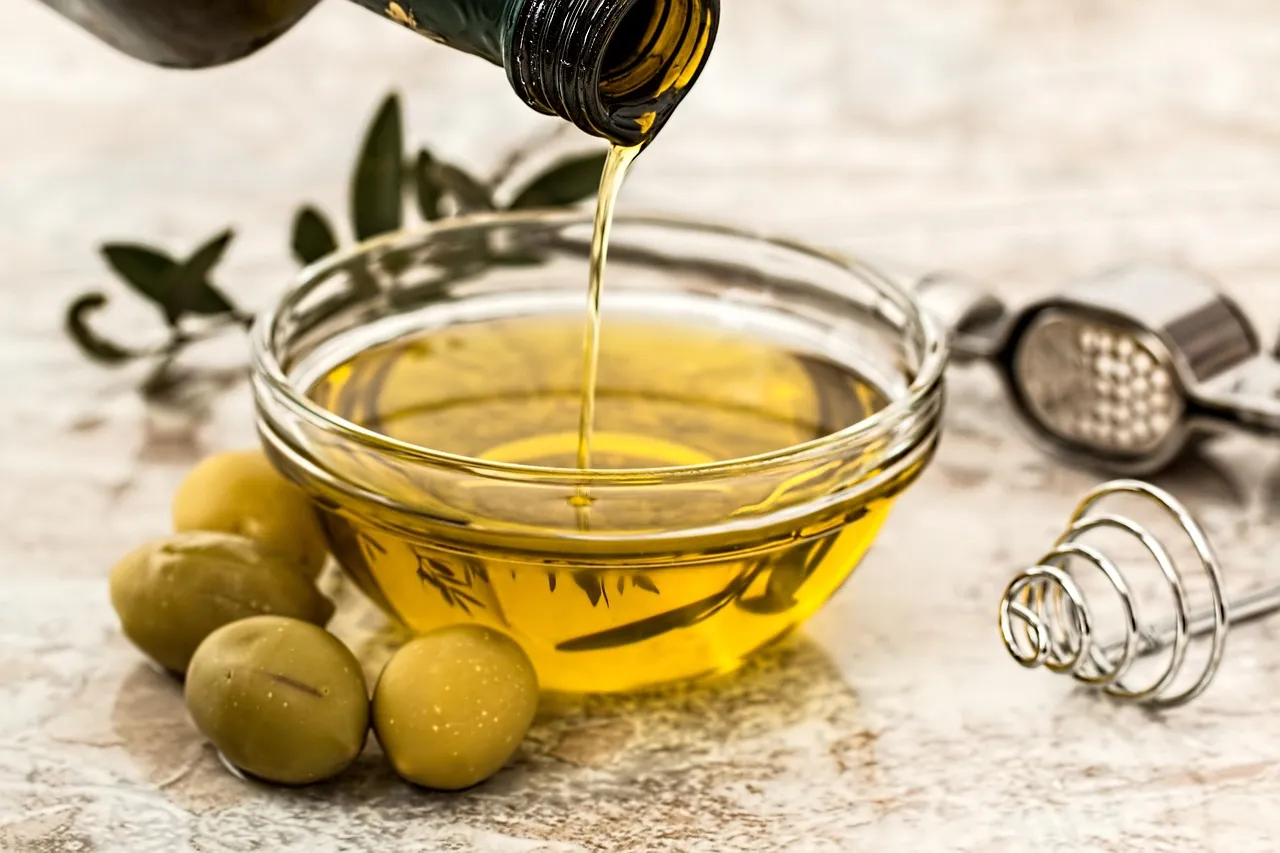 A spread of Mediterranean small plates with olive oil on a table
