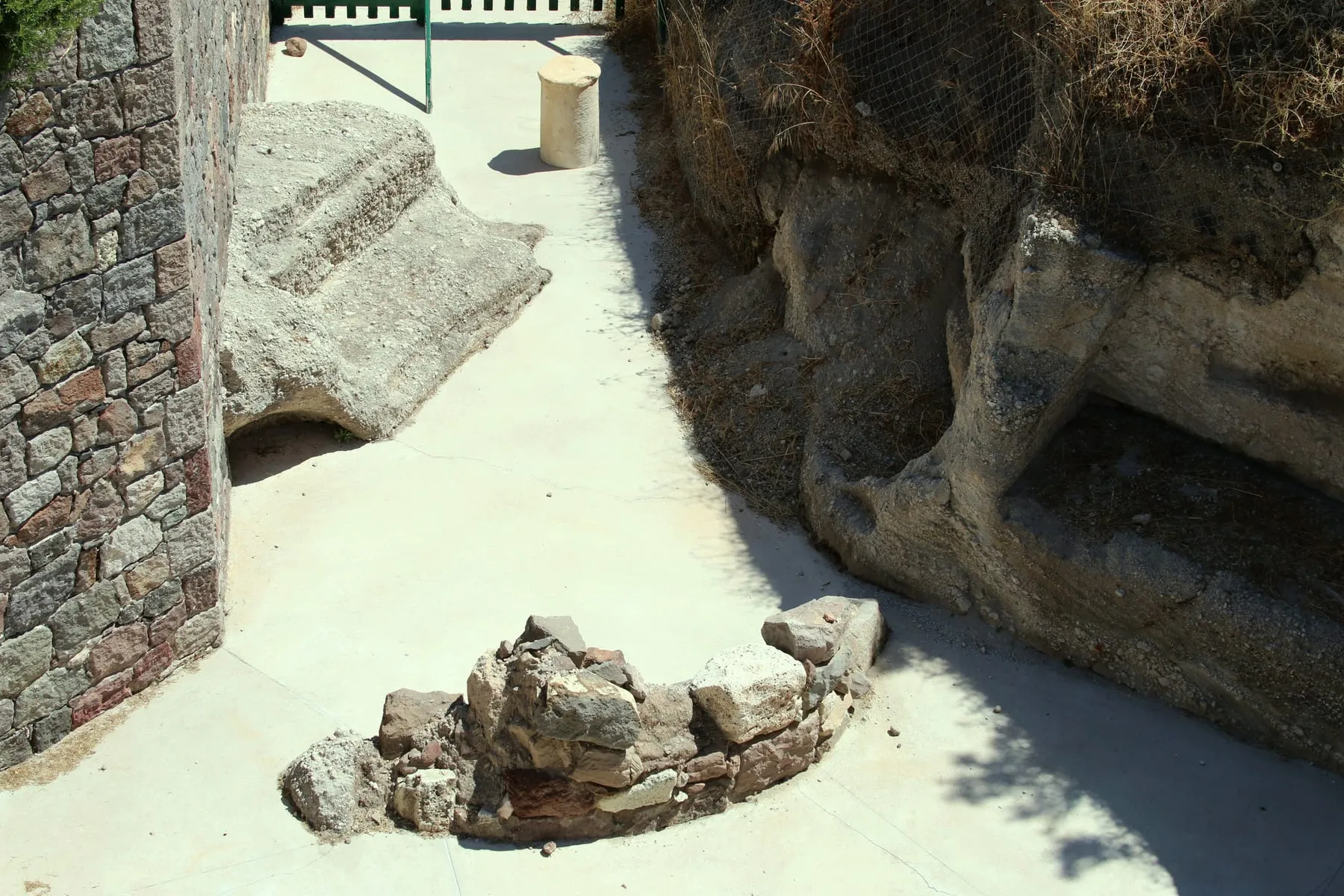 The entrance and volcanic rock exterior of the Catacombs of Milos near Trypiti
