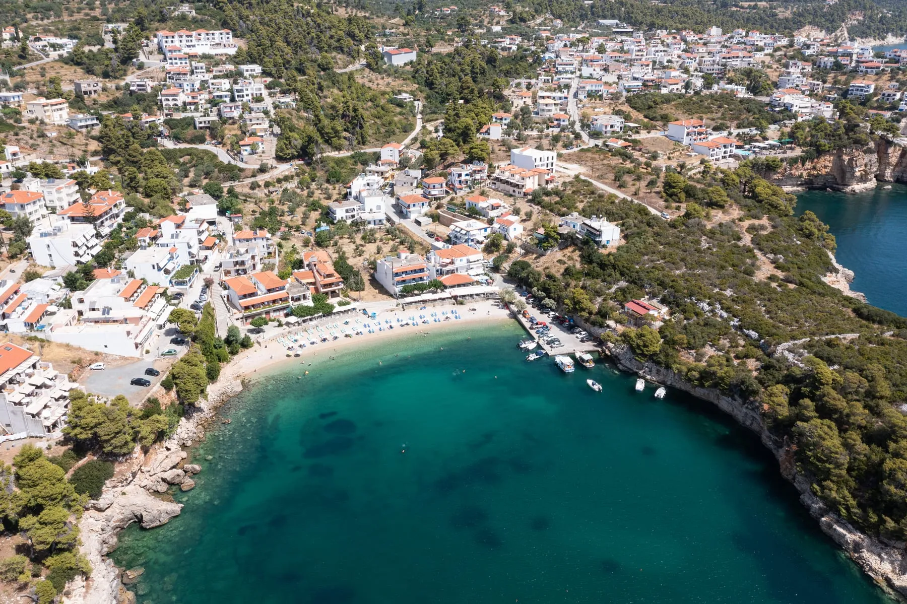Aerial view of Rousoum Gialos beach on Alonissos with green hills and clear water