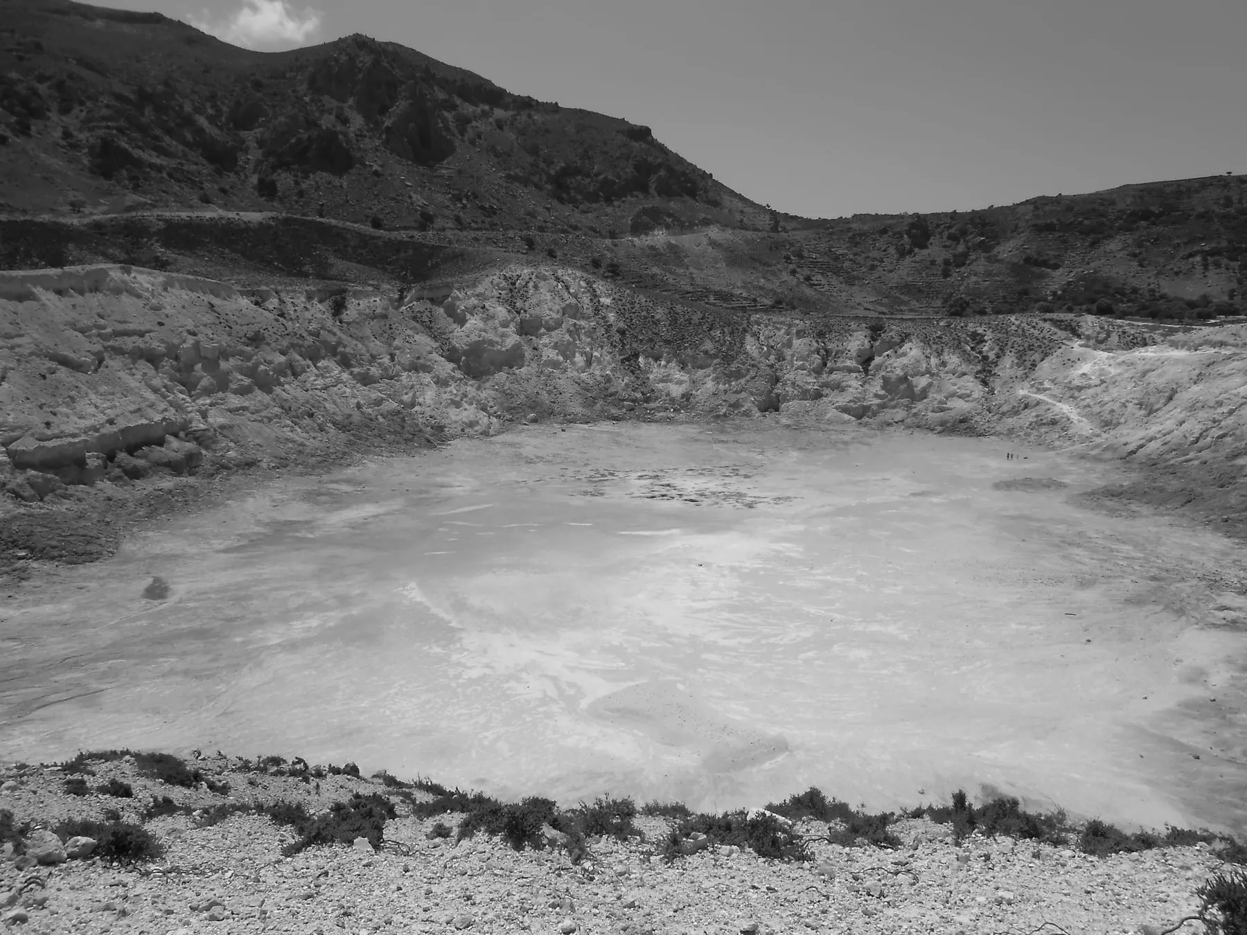 The Stefanos volcanic crater on Nisyros with pale rock and steam vents