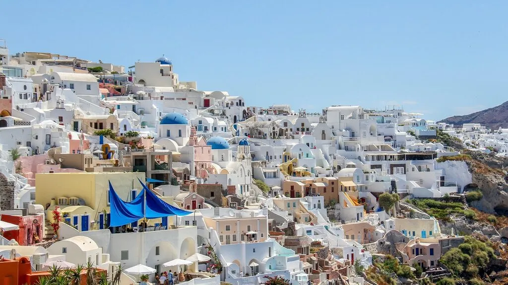 Whitewashed houses and blue domes overlooking the caldera in Oia, Santorini