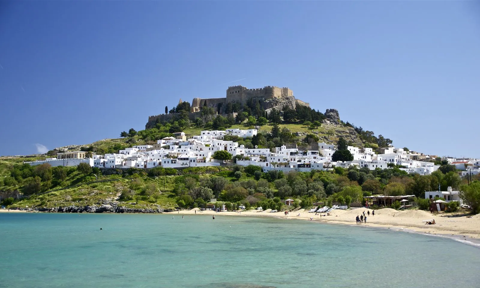 The whitewashed village of Lindos beneath its acropolis on Rhodes, Greece