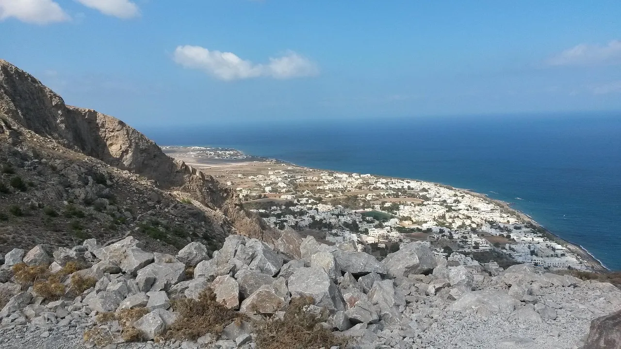 Black sand beach of Kamari below the Mesa Vouno hill on the east coast of Santorini