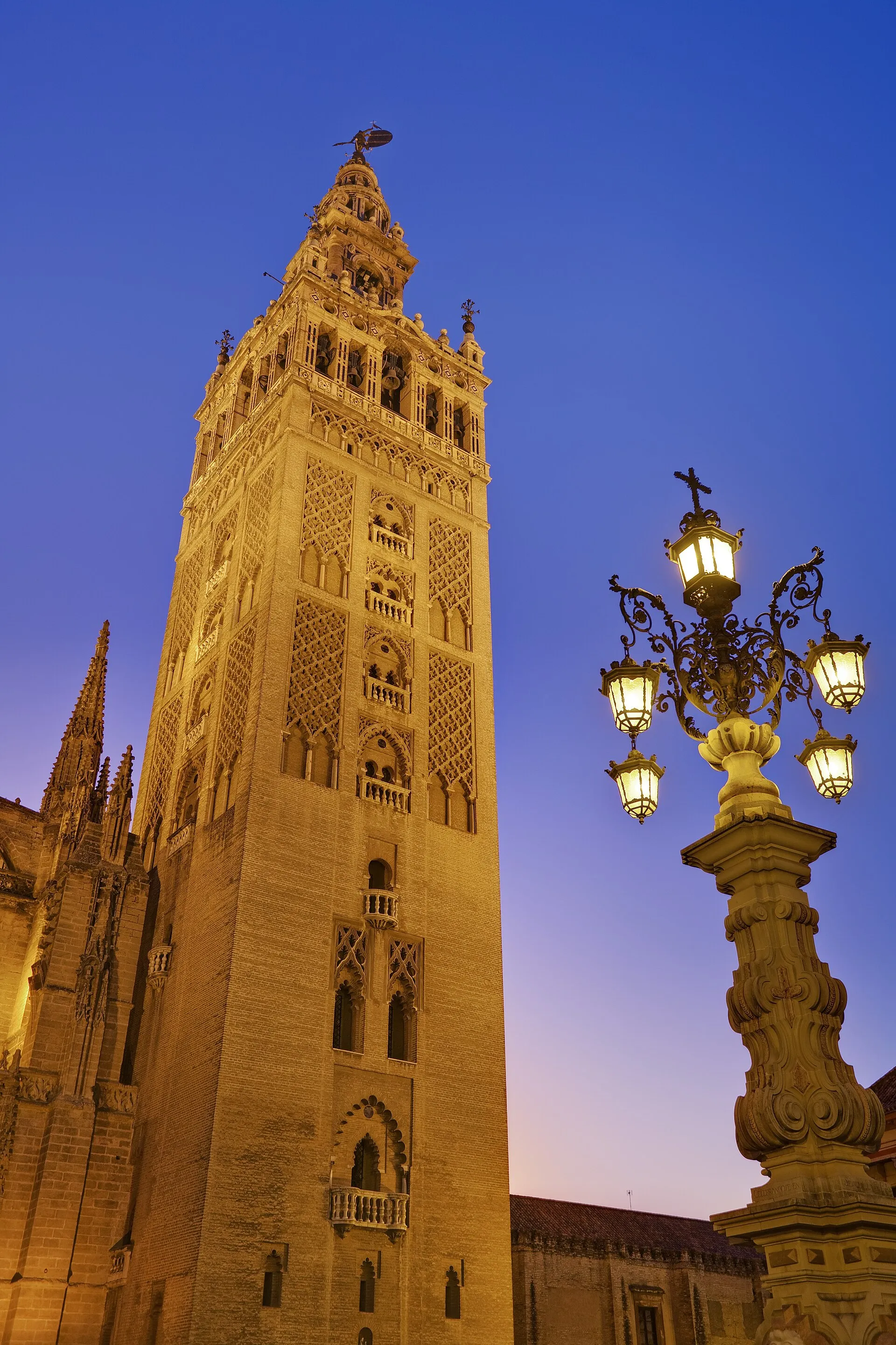The Giralda bell tower of Seville Cathedral seen from the Plaza Virgen de los Reyes